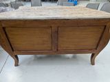 a wooden table with a marble top in the middle of a room