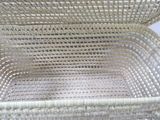a white wicker basket with a handle on it