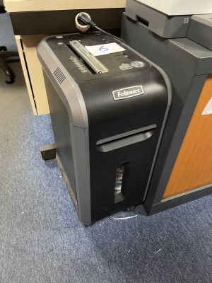 a black and gray paper shredder sitting on the floor