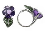 two rings with purple flowers and green crystals on them on a white surface