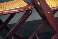 Suite de quatre chaises pliantes cannées en bois teinté. (photo 5)