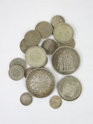 a pile of old coins on a white surface