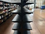 a black shelf with a sign on it in a store