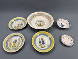 six pieces of blue and yellow plates with a bird on them