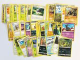a lot of pokemon cards that are on the table