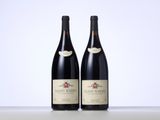 two bottles of wine sitting on top of a table next to each other