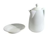 a white coffee pot and a white plate on a white background