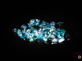some very pretty blue and white diamonds on a black surface
