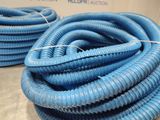blue hoses stacked on top of each other on a table