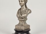 a silver statue of a woman with a wreath on her head