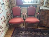 two red chairs in the corner of a room