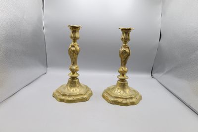 pair of antique brass candlesticks on a white background