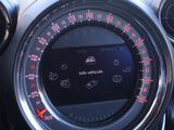 a car dashboard with a digital clock and a steering wheel