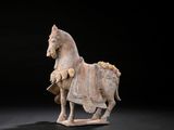 statue of a horse with a rider on it ' s back on a black background