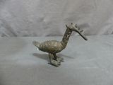 bronze colored bird figurine with a long neck and long legs