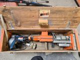 a tool box with a hammer and a drill in it