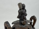 a statue of a man riding a horse on top of a teapot