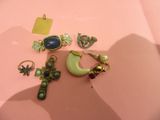 a lot of jewelry that is laying on a pink surface