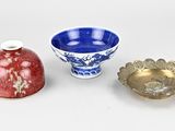 three small bowls and a small bowl are sitting on a white surface