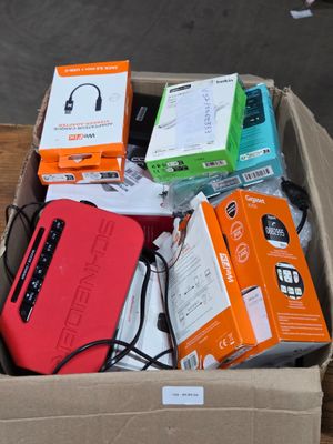 a box full of electronic devices sitting on a wooden table
