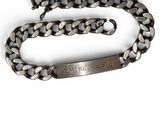 an image of a silver chain bracelet with a name engraved on it