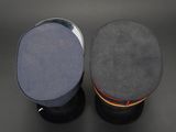 two hats are sitting on top of each other on a black surface