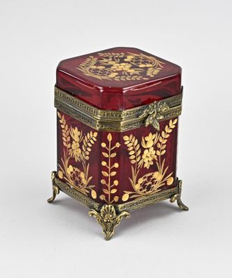 an image of a red and gold box with flowers on it