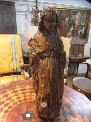 a statue of a woman on a table in a room