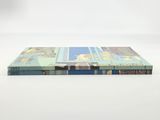 a close up of a book sitting on top of a white surface