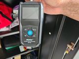 a man holding a digital thermometer in his hand