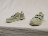 pair of green veja shoes on a white background