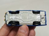 a person holding a toy car in their hand