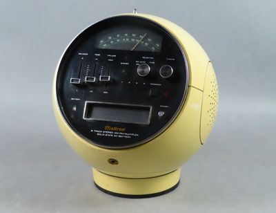 a yellow clock that is sitting on top of a table
