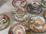 a lot of tea cups and saucers on the table