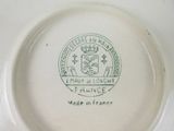 a plate with a picture of a coat of arms and a crown on it