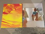 someone is taking a picture of a woman in a photo book