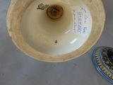 a vase that is sitting on a table with a lid