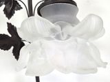 a glass vase with a flower inside of it