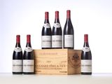 six bottles of red wine in a wooden box on a table