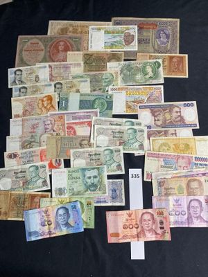 many different types of currency on a black table