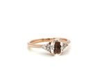 a close up of a ring with a brown and white diamond