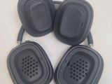 three black headphones are sitting on a white surface