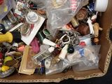 a cardboard box filled with assorted items and key chains