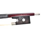 a violin bow with a red handle on a white background