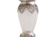 une photo d'un vase argenté posé sur une table blanche