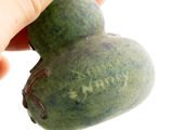 a person holding a green heart shaped object in their hand