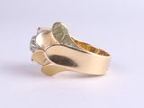 yellow gold ring with a leaf design and a diamond accent