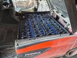 a fork truck with a bunch of tools in the back of it