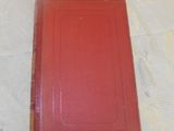 a red book sitting on top of a white table
