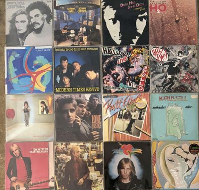 many different album covers are arranged on the floor